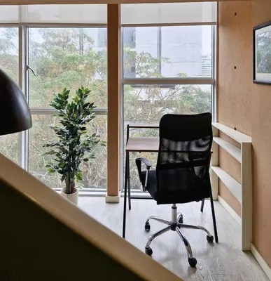 a black office chair sitting in front of a desk at Spacio 299 by Geko in Lima