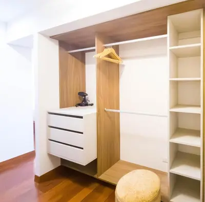 a closet with white cabinets and a stool at Meridian 3BR by Geko in Lima