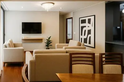 a living room with a couch and chairs and a tv at Meridian 3BR by Geko in Lima