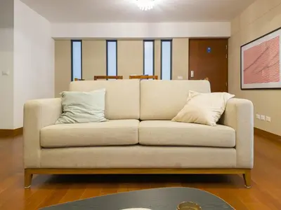 a couch with two pillows sitting in a living room at Meridian 3BR by Geko in Lima