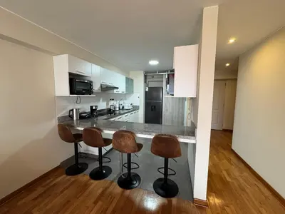 a kitchen with a bar with two stools at Miraflores 1 Bedroom Executive Apartment in Lima