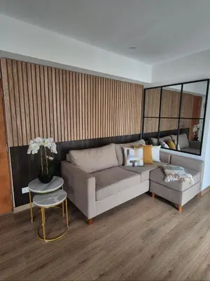 a living room with a couch and a table at Hermoso apartamento in Lima