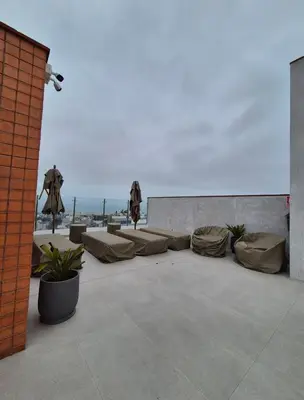 a patio with couches and chairs on top of a building at Hermoso apartamento in Lima