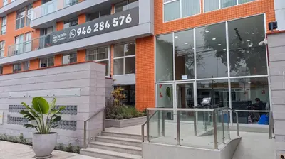a building with a glass revolving door in front of it at Hermoso apartamento in Lima