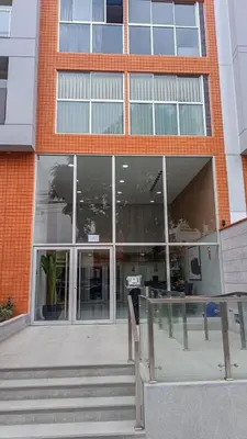 a large brick building with stairs in front of it at Hermoso apartamento in Lima