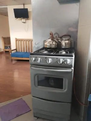 a kitchen with a stove with pots and pans on it at TantaWasi in Cusco