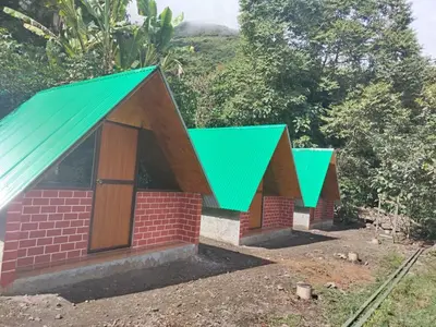 a small train station with green roofs at Lucmabamba Cottage in Sahuayacu