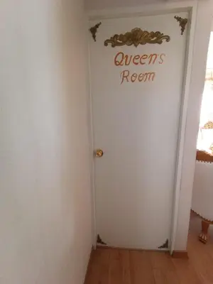 a white door with a sign that reads queens room at Versalles Apartment in Lima