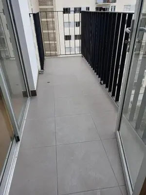 an empty corridor in a building with glass doors at Versalles Apartment in Lima