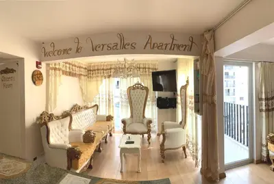 a living room with couches and a sign that reads a home is rentals agreement at Versalles Apartment in Lima