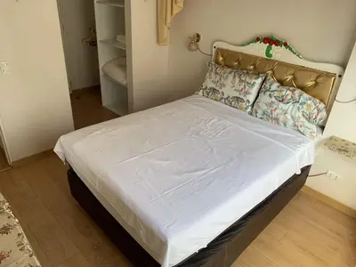a bed in a bedroom with a white bedspread and pillows at Versalles Apartment in Lima