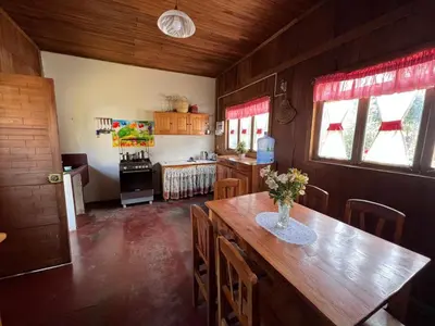 a kitchen with a wooden table and a dining room at Schütze-Haus in Oxapampa