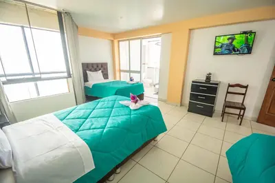 a hospital room with two beds and a tv at VILLA andina cusco in Cusco