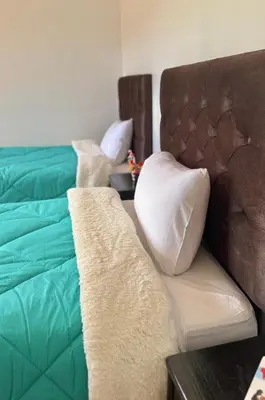 a bedroom with two beds with pillows on them at VILLA andina cusco in Cusco