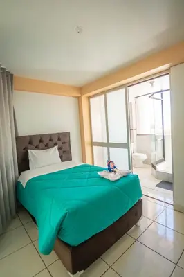 a bedroom with a large bed and a bathroom at VILLA andina cusco in Cusco