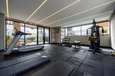a room with a gym with a slide and a treadmill at BSR Cozy Flat next to Av. Javier Prado w/ Pool&Gym in Lima