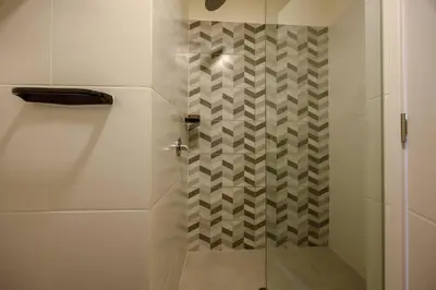 a bathroom with a shower with a glass door at BSR Cozy Flat next to Av. Javier Prado w/ Pool&Gym in Lima