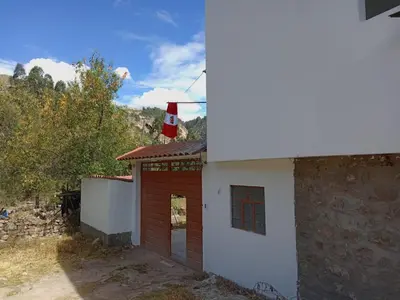a small building with a flag on top of it at Hotel Campestre Corina