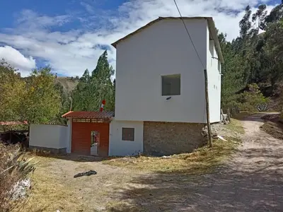 a small white building on the side of a road at Hotel Campestre Corina