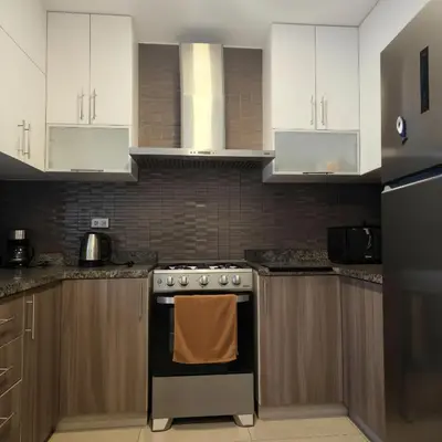 a kitchen with white cabinets and an oven at E Malecon Larcomar Free Parking 3B 102 in Lima