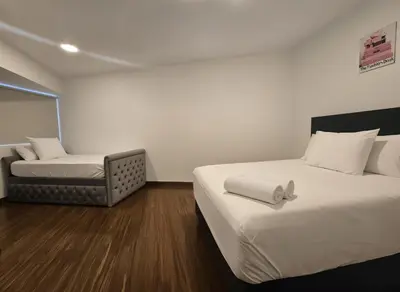 a bedroom with two beds and a chair at E Malecon Larcomar Free Parking 3B 102 in Lima