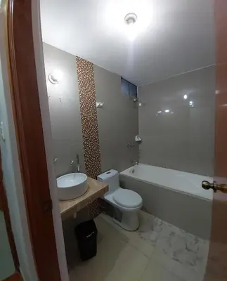 a bathroom with a sink and a toilet and a bath tub at In house ica in Ica
