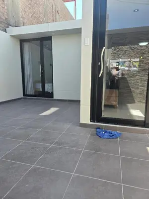 a tiled floor in front of a glass door at Un house ica in Ica
