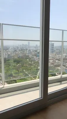 an open window with a view of a city at Urbana Perú Tempo in Lima