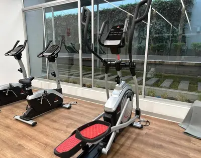 a gym with three exercise bikes in a room at Urbana Perú Tempo in Lima