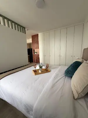 a large white bed in a bedroom with a table at The Sight in Lima