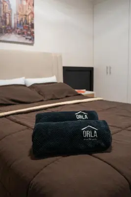 a black towel sitting on top of a bed at Casa viajera - orla los topacios in Lima