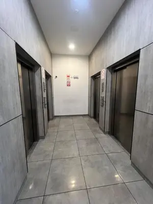 a hallway of a building with doors and tile floors at Casa viajera - orla los topacios in Lima