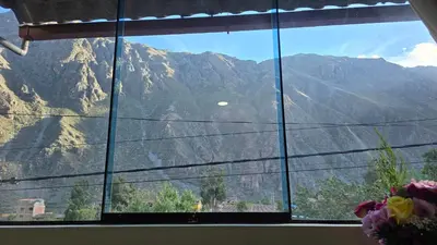 a window with a view of a mountain view at Refugio Sagrado Boutique in Ollantaytambo
