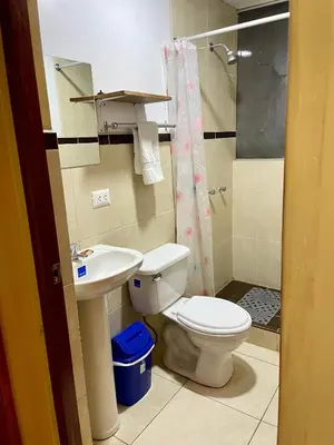 a bathroom with a toilet and a sink and a shower at TORIBIANS Hotel in Chinchero