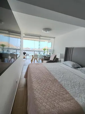 a bedroom with a bed and a view of the ocean at Confortable con vista al mar de Naplo, Pucusana in Pucusana