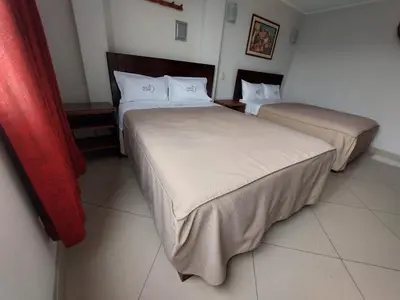 a room with two beds in a room at Hospedaje El Jardín in Lima