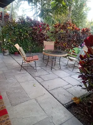 a patio with chairs and a table and a table and chairs at Rustic House, Pool, Grill, Game Area, Campfire Area in Cieneguilla