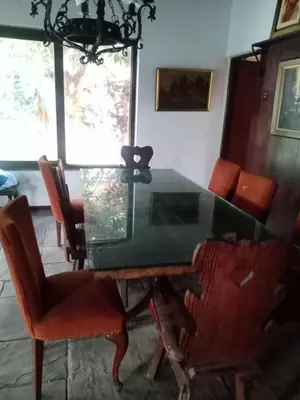 a dining room with a glass table and chairs at Rustic House, Pool, Grill, Game Area, Campfire Area in Cieneguilla