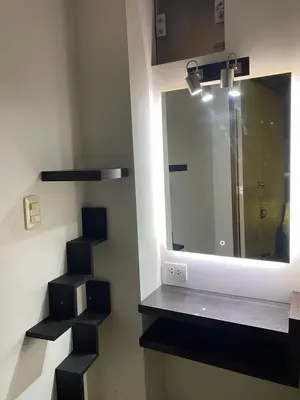 a bathroom with a sink and a mirror and stairs at Casa Olivo in Lima