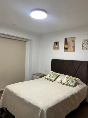 a bedroom with a large bed with two pillows at Miraflores premiere apartment in Lima
