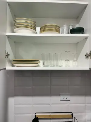a white shelf with plates and dishes on it at Miraflores premiere apartment in Lima