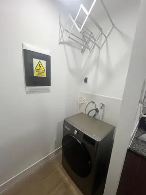 a bathroom with a toilet and a sign on the wall at Miraflores premiere apartment in Lima