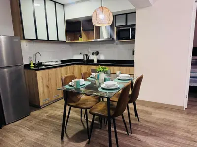 a kitchen with a table with chairs and a refrigerator at Era 24 mala puntuacion in Lima