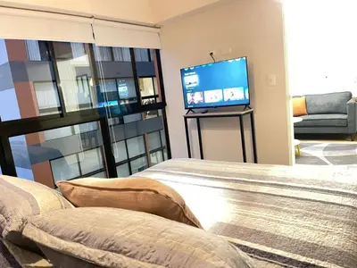 a living room with a bed and a flat screen tv at Era 24 mala puntuacion in Lima