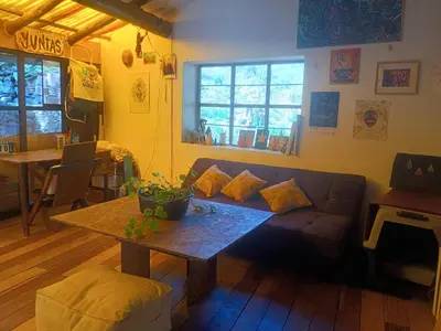a living room with a couch and a table at Yuntawasi Cozy mini Ollantaytambo in Ollantaytambo