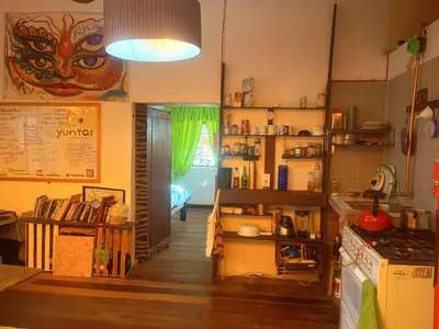 a room with a kitchen with a table and a stove at Yuntawasi Cozy mini Ollantaytambo in Ollantaytambo