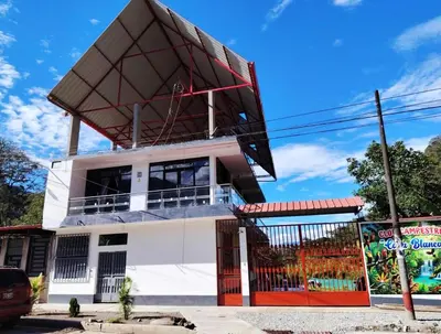 a building with a roof on top of it at Casa familiar con parrilla, piscina, WiFi y cesped