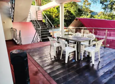 a table and chairs on a deck with stairs at Casa familiar con parrilla, piscina, WiFi y cesped