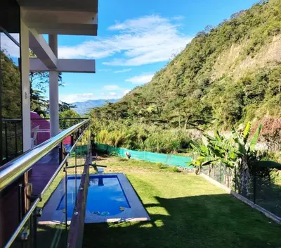 a balcony of a house with a view of a mountain at Casa familiar con parrilla, piscina, WiFi y cesped