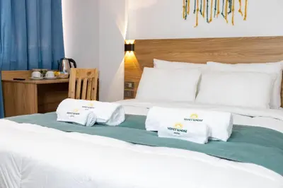 a bedroom with a bed with two towels on it at Velvet Sunrise Hotel in Machu Picchu